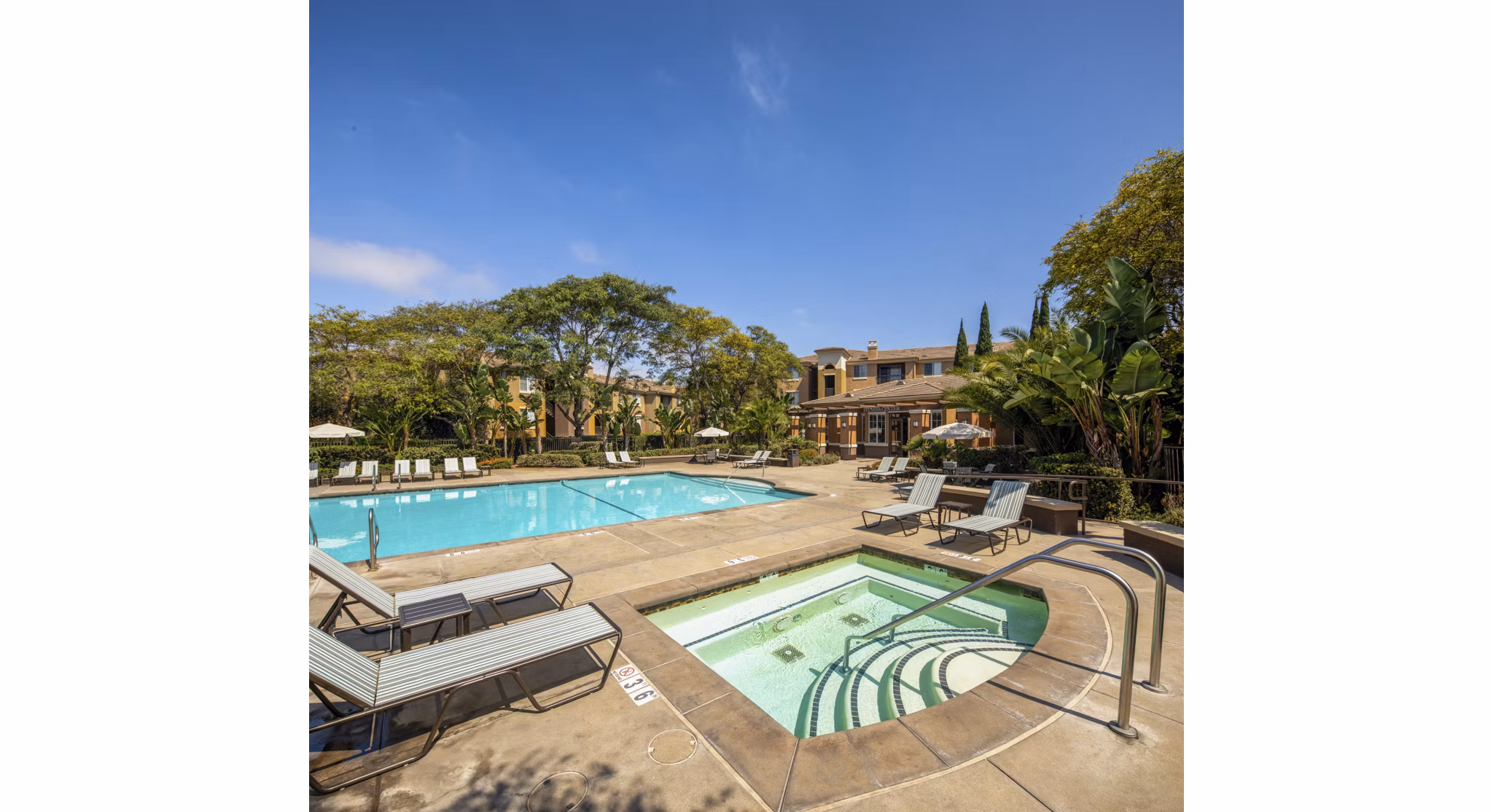 Resort-style pool with lounging chairs at Casoleil Apartments in vibrant luxury community