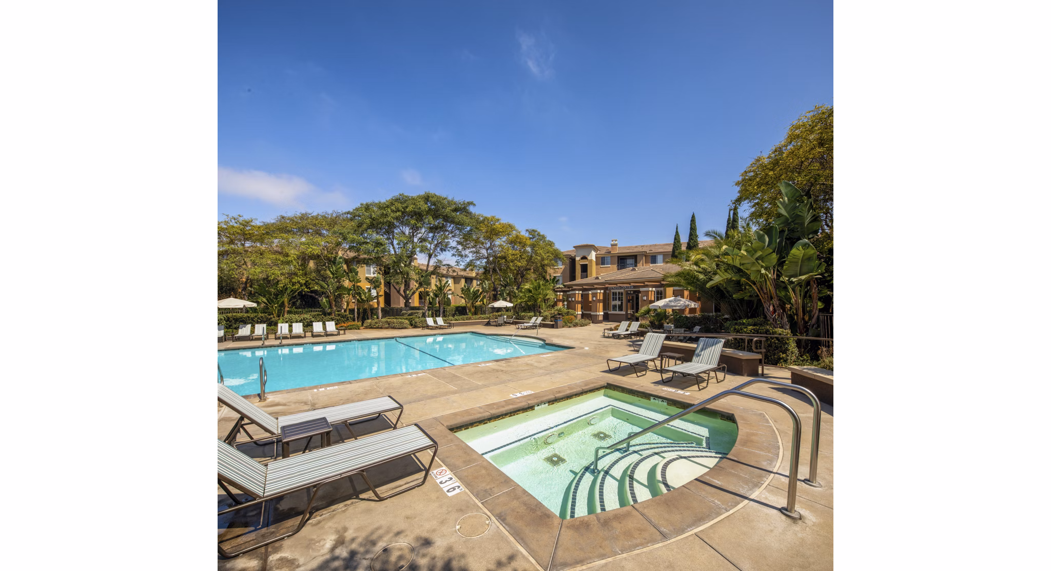 Resort-style pool with lounging chairs at Casoleil Apartments in vibrant luxury community