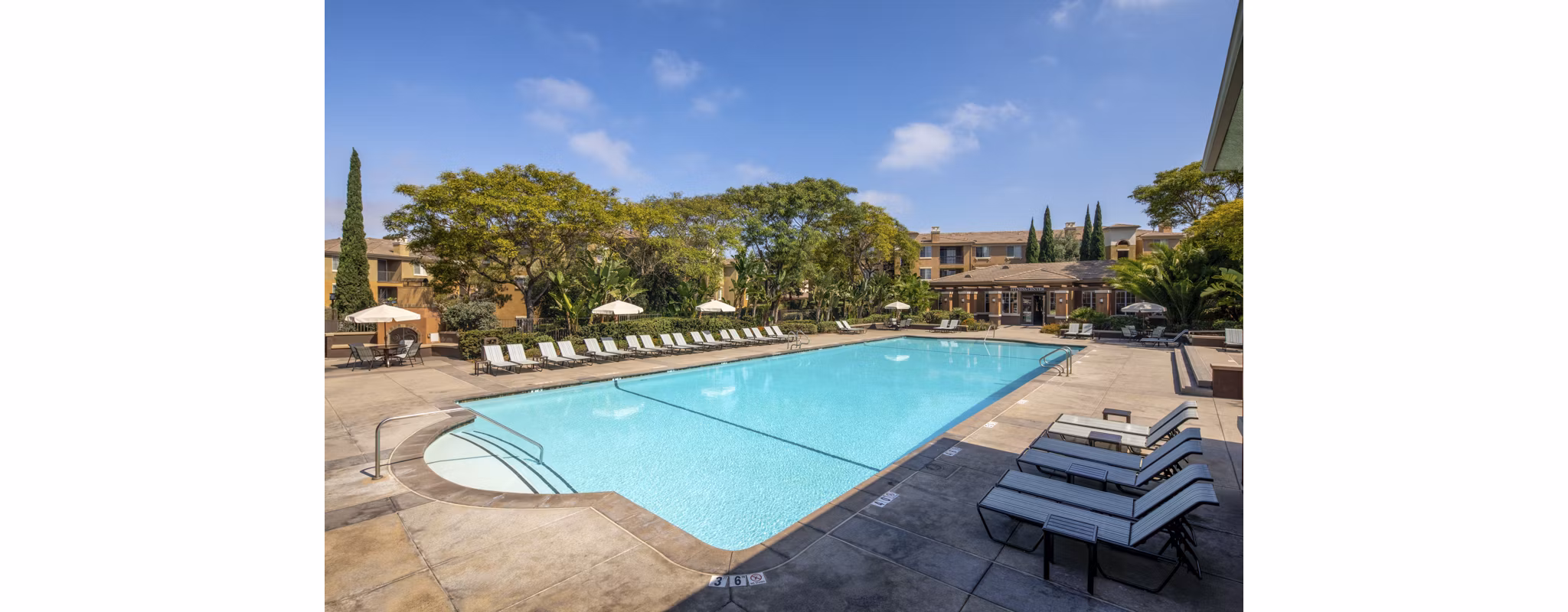 Resort-style pool with lounging areas at Casoleil Apartments, a luxury property offering relaxation and recreation