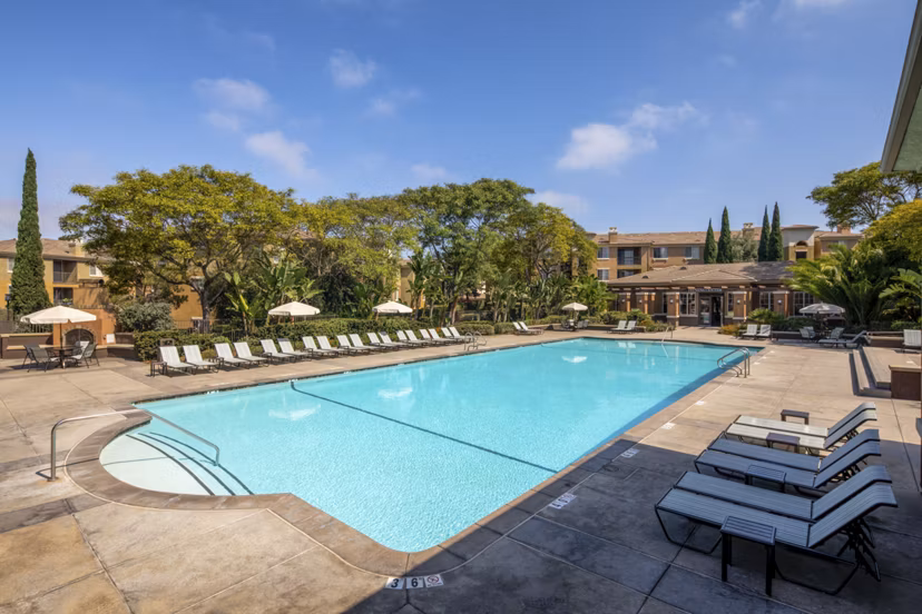 Resort-style pool with lounging areas at Casoleil Apartments, a luxury property offering relaxation and recreation