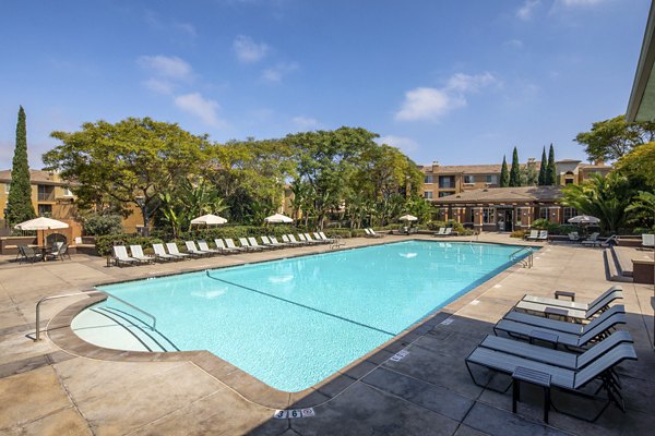 Resort-style pool with lounging areas at Casoleil Apartments, a luxury property offering relaxation and recreation