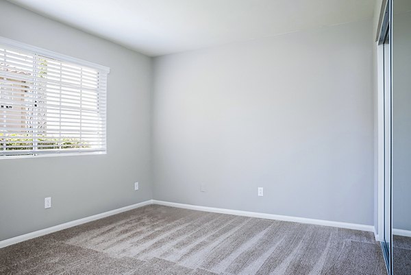 Cozy bedroom with modern furnishings at Central Park Apartments