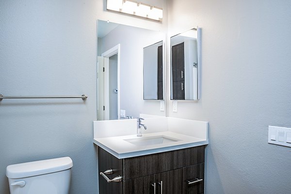 Luxurious bathroom with marble countertops and modern fixtures at Central Park Apartments