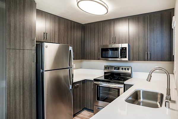 Modern kitchen with stainless steel appliances at Central Park Apartments