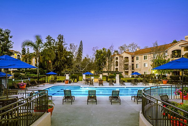 Luxurious outdoor pool with sun loungers at Central Park Apartments, ideal for relaxation and leisure