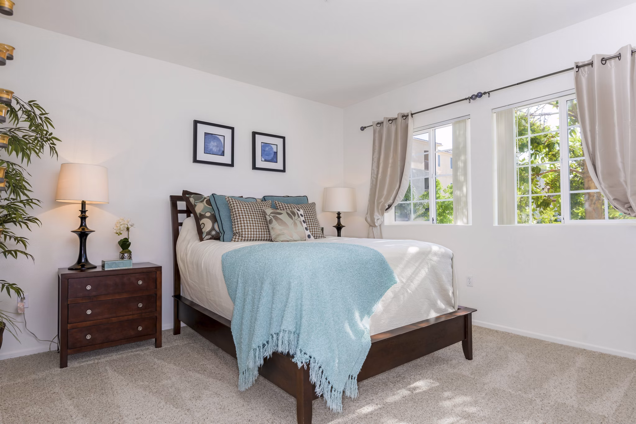 Cozy bedroom with modern furnishings at Greenfield Village Apartments in luxury Greystar community