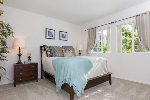Cozy bedroom with modern furnishings at Greenfield Village Apartments in luxury Greystar community