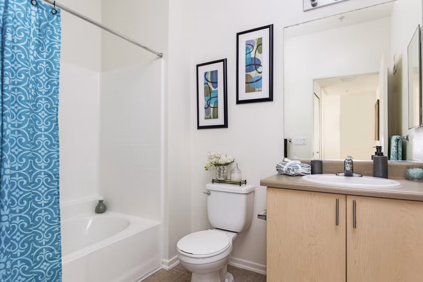 Stylish bathroom with modern fixtures at Greenfield Village Apartments, featuring sleek tile work and spacious vanity