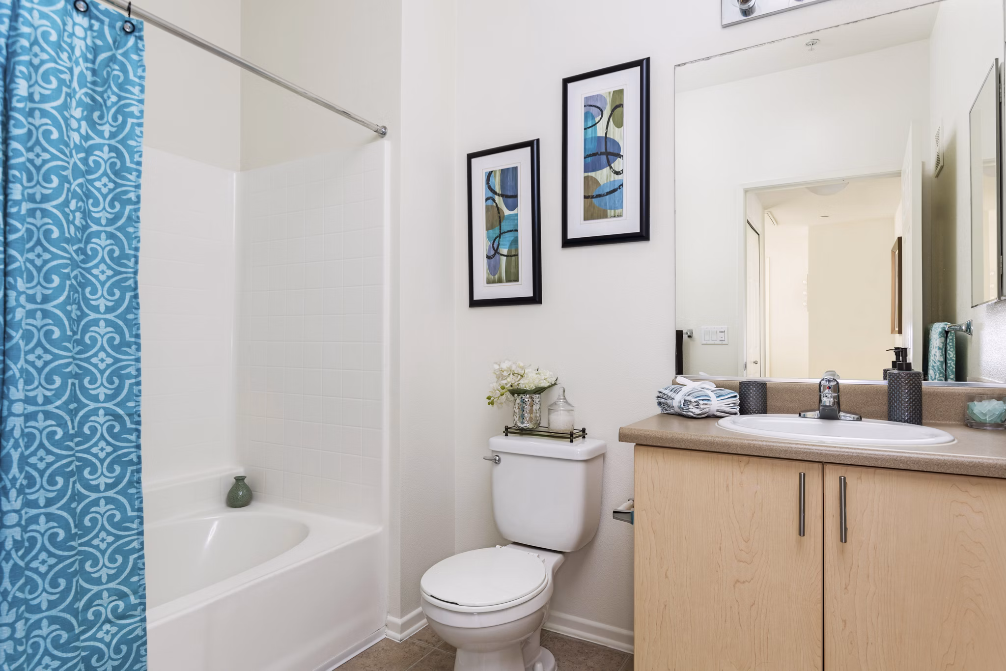 Stylish bathroom with modern fixtures at Greenfield Village Apartments, featuring sleek tile work and spacious vanity