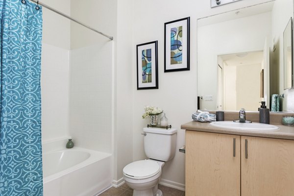 Stylish bathroom with modern fixtures at Greenfield Village Apartments, featuring sleek tile work and spacious vanity