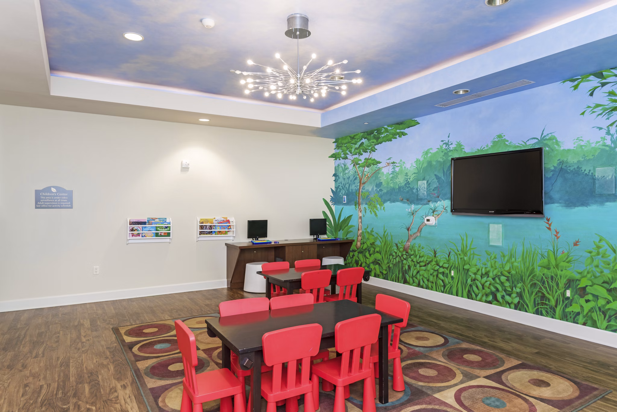 Game room with pool table and lounge seating at Greenfield Village Apartments