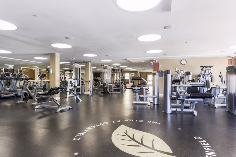 Modern fitness center with state-of-the-art equipment at Greenfield Village Apartments, offering a luxury workout experience