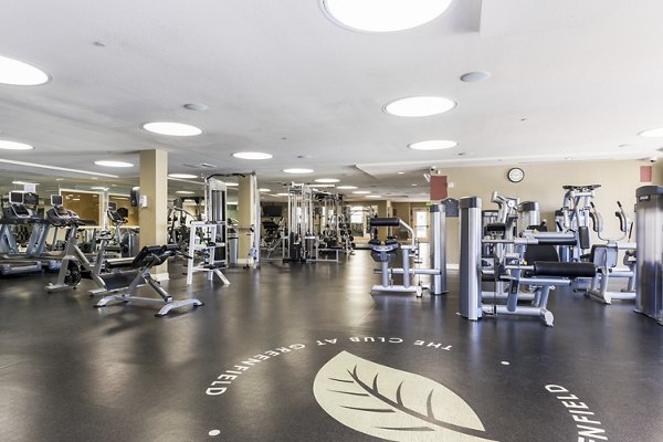 Modern fitness center with state-of-the-art equipment at Greenfield Village Apartments, offering a luxury workout experience