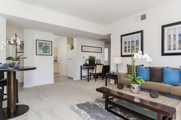 Inviting living room featuring modern furnishings and natural light at Greenfield Village Apartments, luxury Greystar community