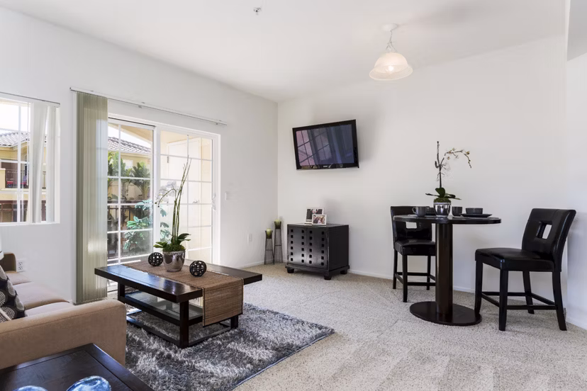 Elegant living room with modern furnishings and natural light at Greenfield Village Apartments