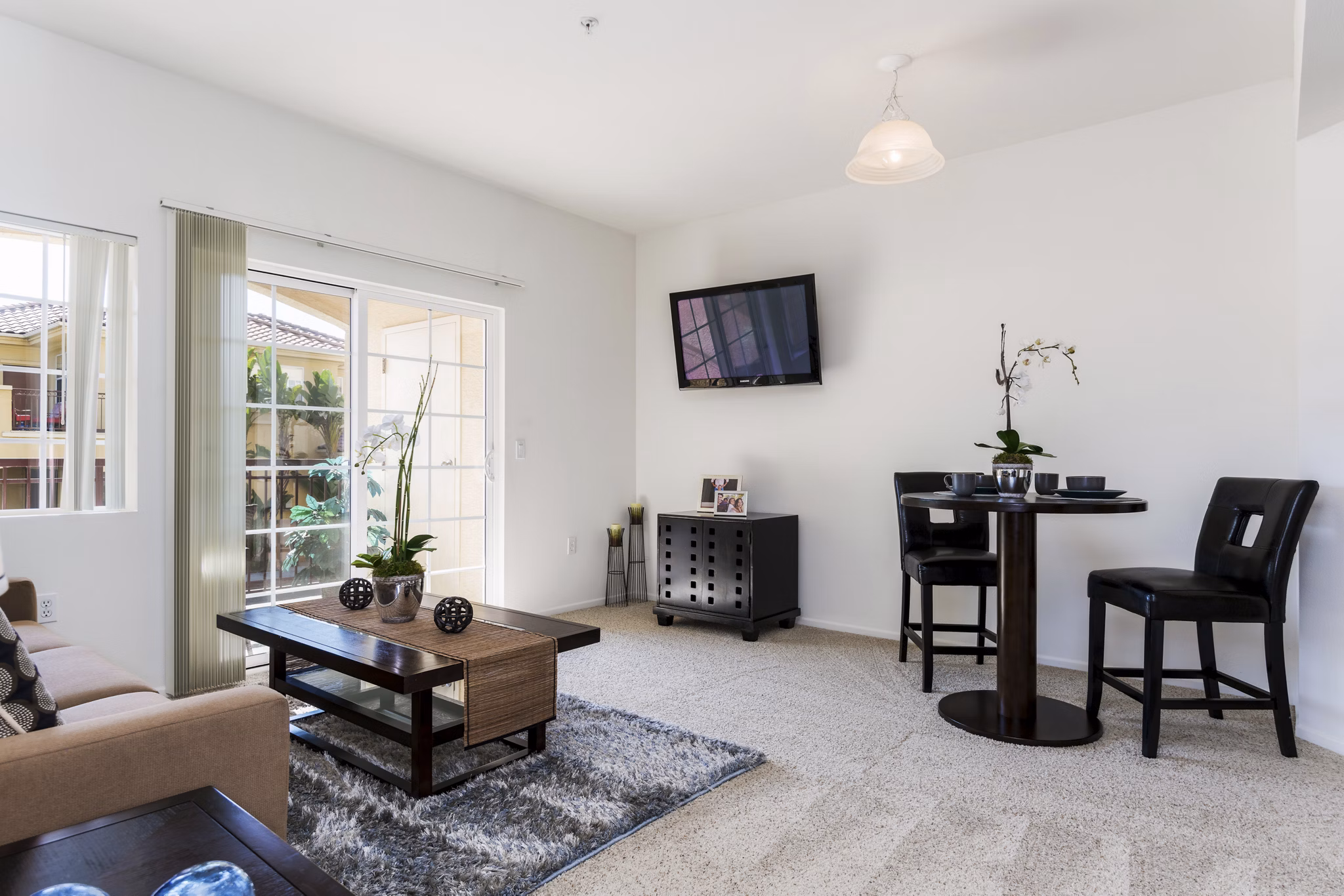 Elegant living room with modern furnishings and natural light at Greenfield Village Apartments