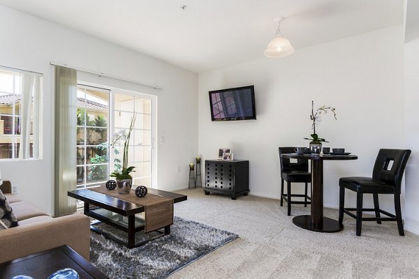 Elegant living room with modern furnishings and natural light at Greenfield Village Apartments