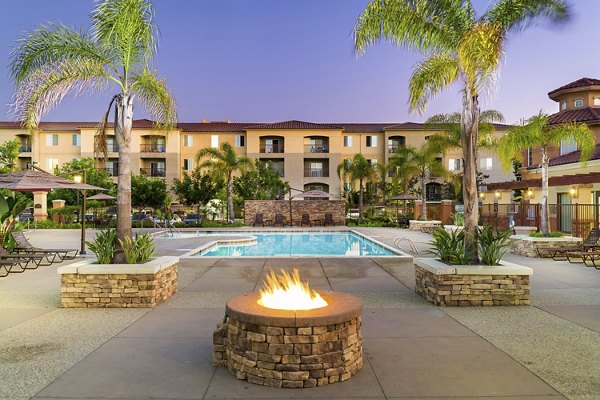 Cozy outdoor fire pit at Greenfield Village Apartments, perfect for social gatherings and relaxation in a luxurious setting