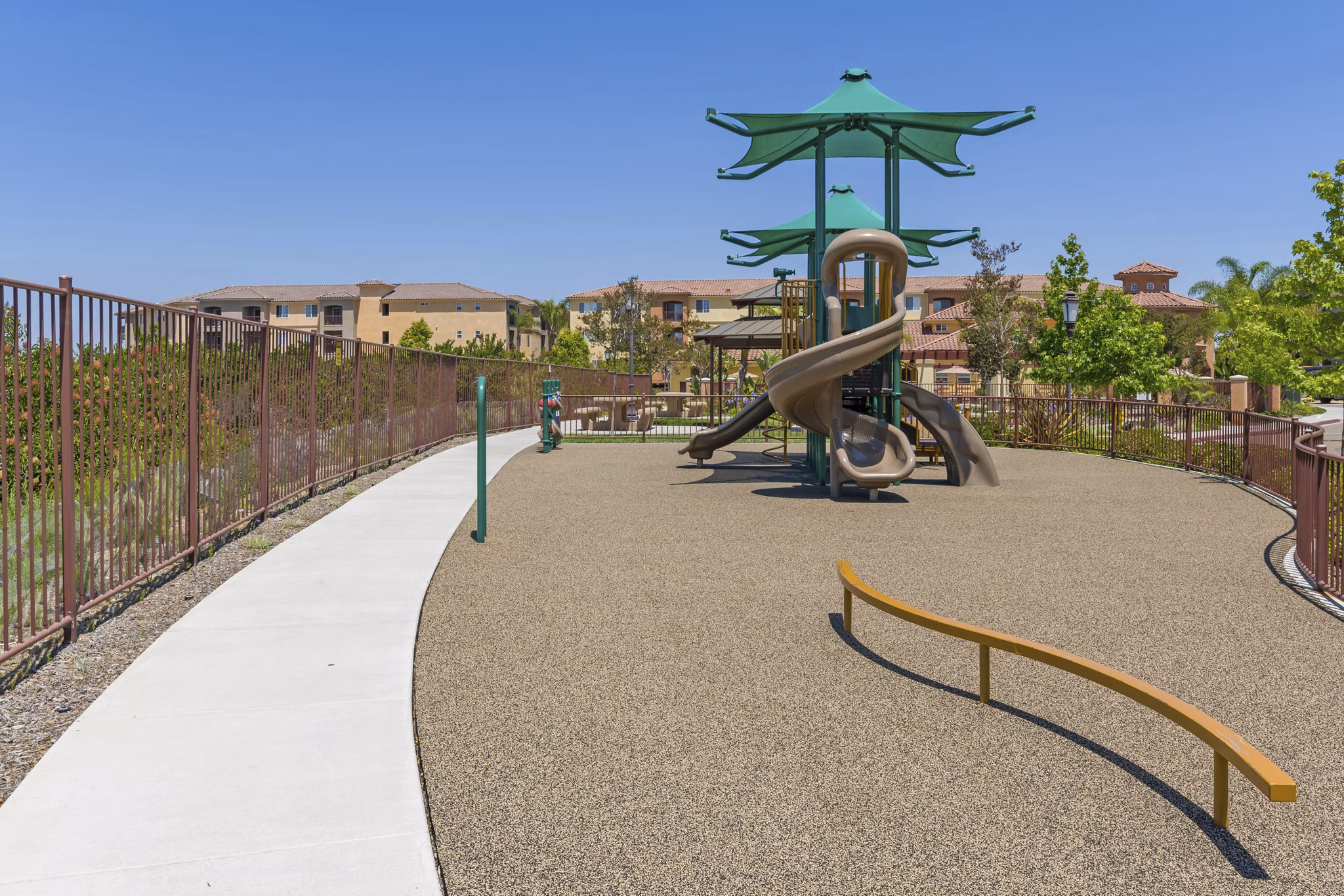 Colorful playground with slides and swings at Greenfield Village Apartments