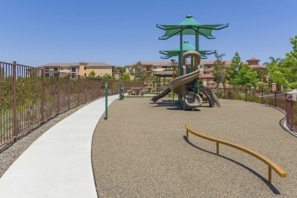 Colorful playground with slides and swings at Greenfield Village Apartments