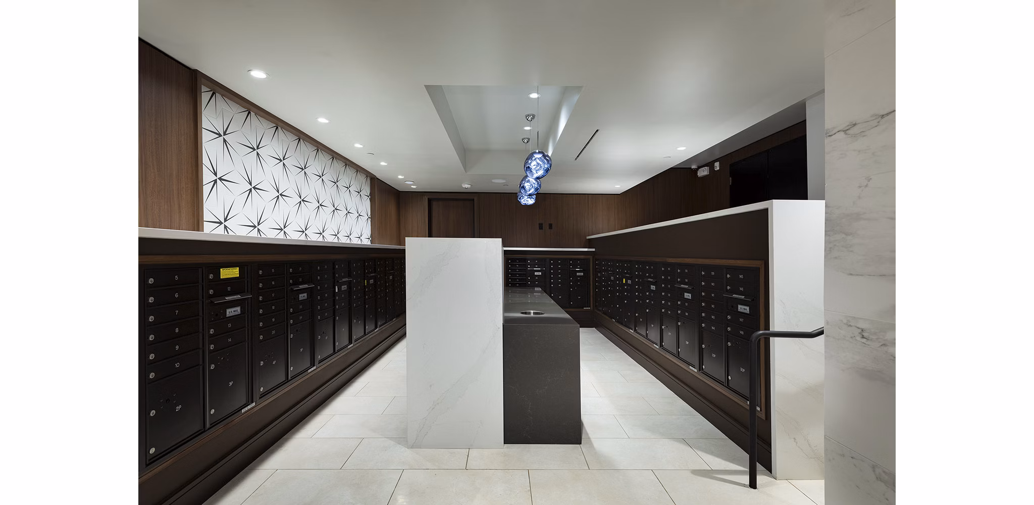 Mail room with locker system at Hanover West LA Apartments