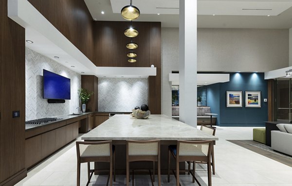 Clubhouse with modern seating and large TV at Hanover West LA Apartments
