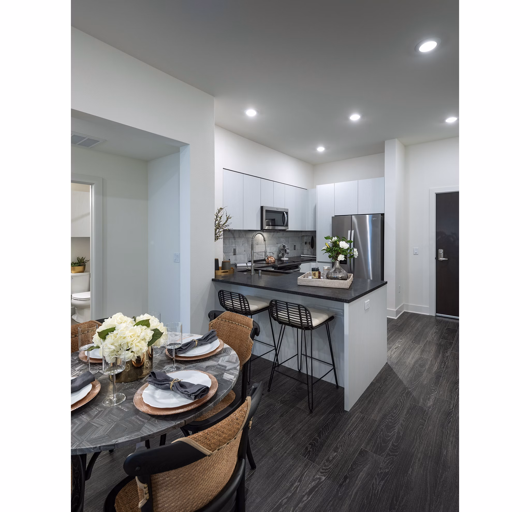 Dining area with modern seating and lighting at Hanover West LA Apartments, showcasing luxury living and stylish interior design
