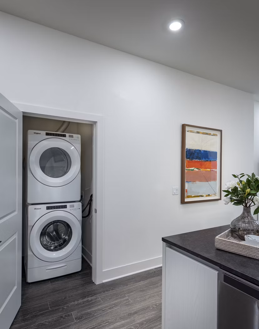 Laundry room equipped with modern appliances at Hanover West LA Apartments