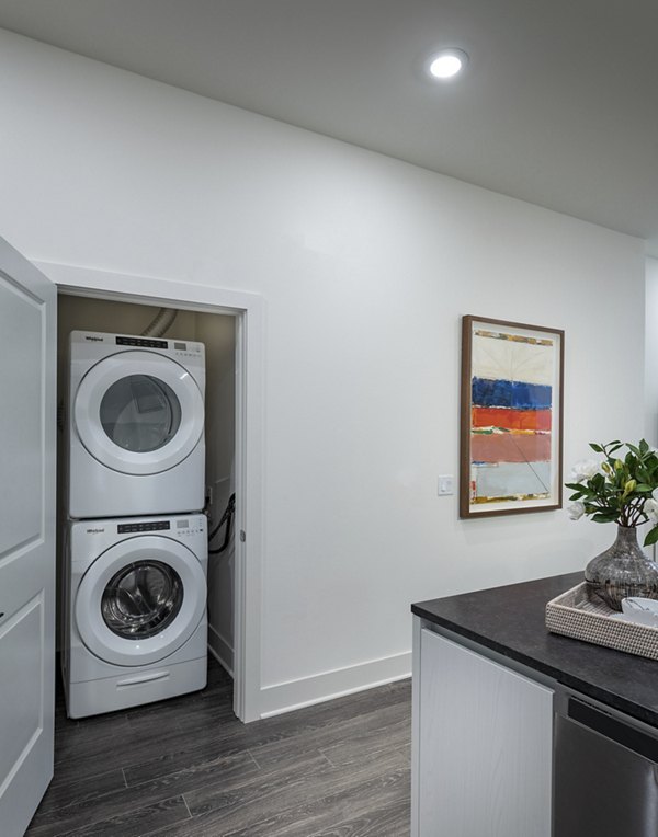 Laundry room equipped with modern appliances at Hanover West LA Apartments
