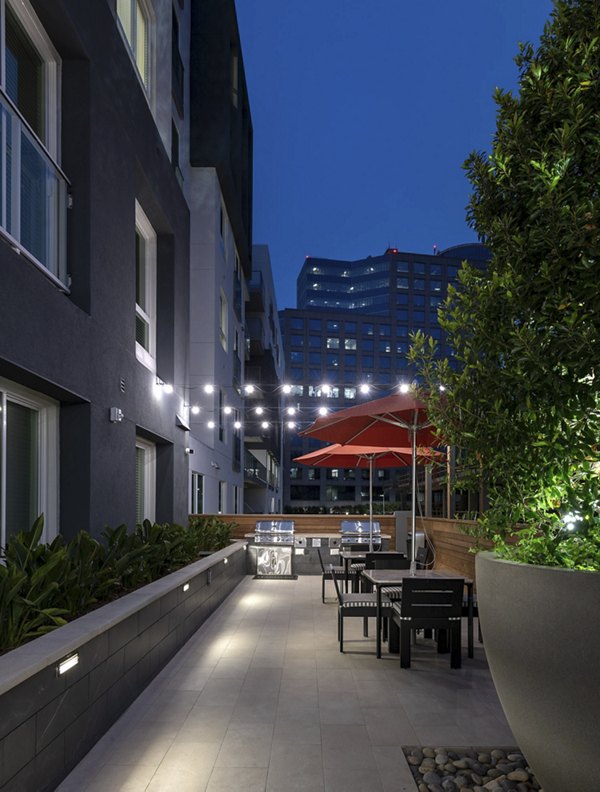 Grill area with outdoor seating at Hanover West LA Apartments for social gatherings and relaxation