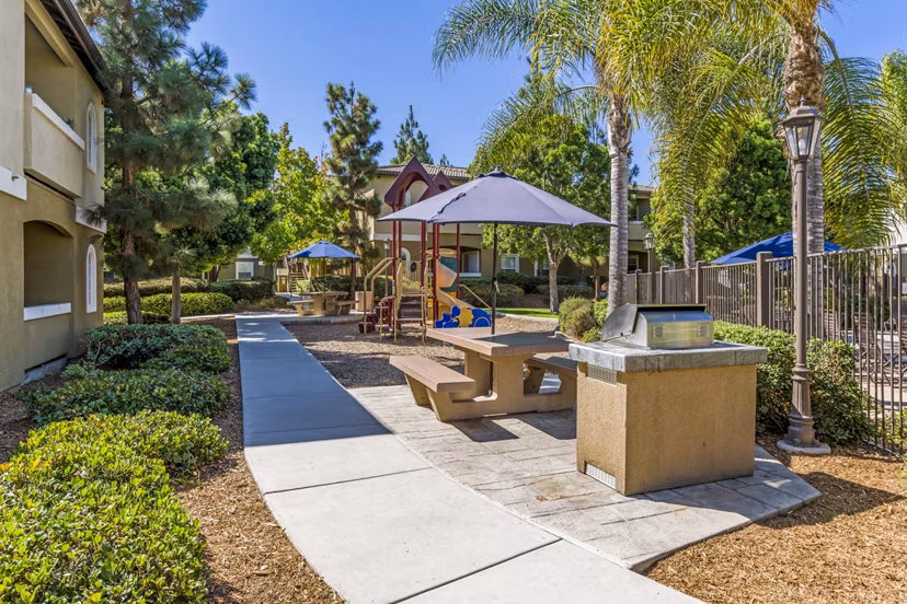 Family-friendly playground and grill area at The Landing at Ocean View Hills Apartments