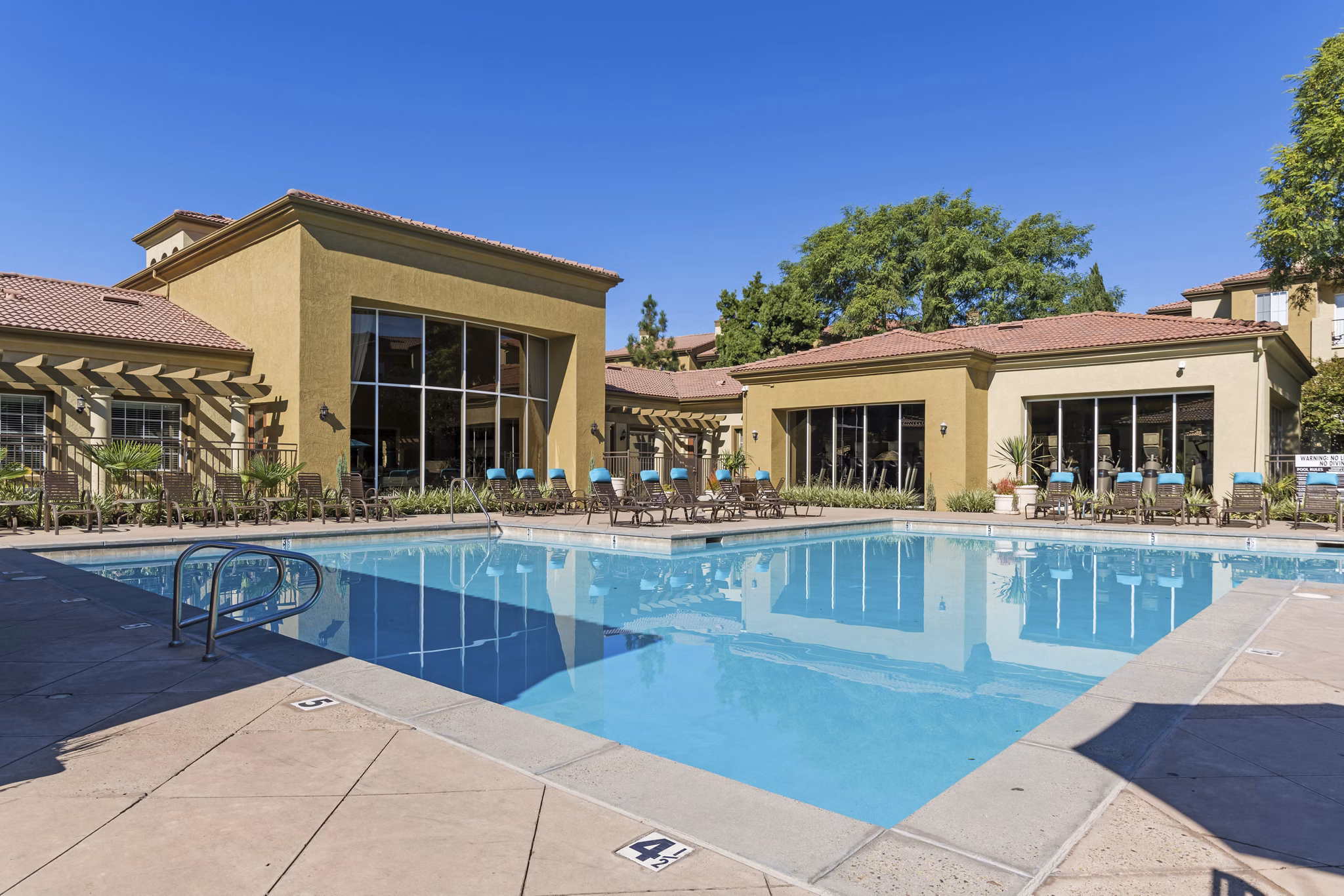 Rooftop pool with lounge seating at Legacy Apartments offering city views