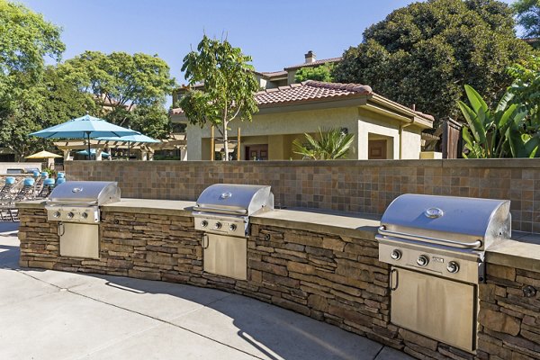 Grill area with outdoor seating at Legacy Apartments, a luxury community by Greystar