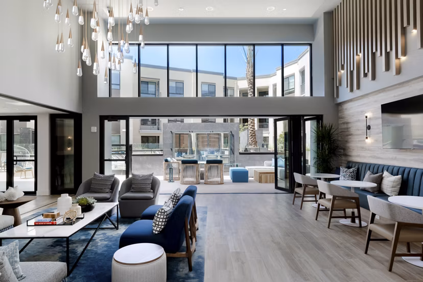 The Lofts at Carlsbad Village: Modern clubhouse lobby featuring sleek design and comfortable seating in luxury apartments
