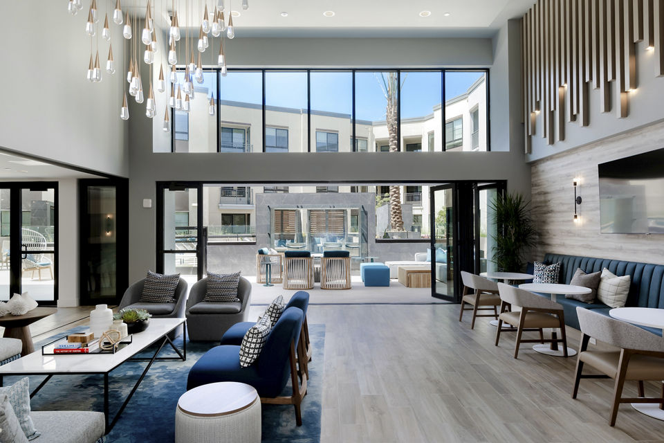 The Lofts at Carlsbad Village: Modern clubhouse lobby featuring sleek design and comfortable seating in luxury apartments
