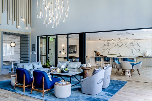 Clubhouse lobby featuring modern design and comfortable seating in The Lofts at Carlsbad Village Apartments