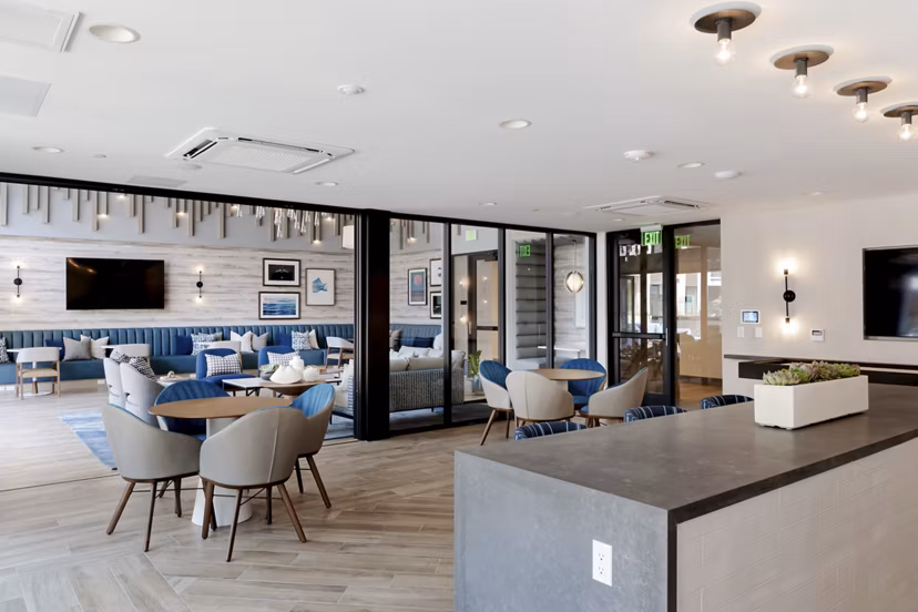 Clubhouse lobby showcasing modern design and relaxing seating at The Lofts at Carlsbad Village Apartments in Carlsbad