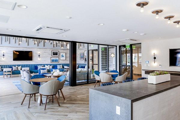 Clubhouse lobby showcasing modern design and relaxing seating at The Lofts at Carlsbad Village Apartments in Carlsbad