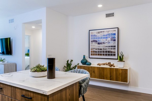 Dining room featuring modern decor and ample natural light at The Lofts at Carlsbad Village Apartments