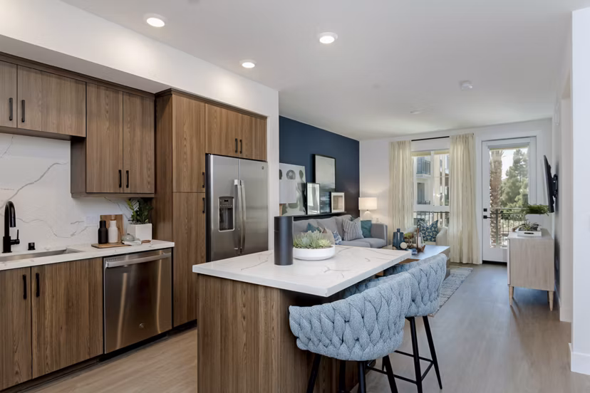 Modern kitchen with stainless steel appliances at The Lofts at Carlsbad Village Apartments