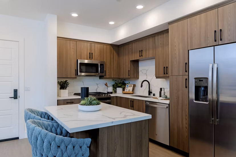 Sleek modern kitchen with stainless steel appliances at The Lofts at Carlsbad Village Apartments