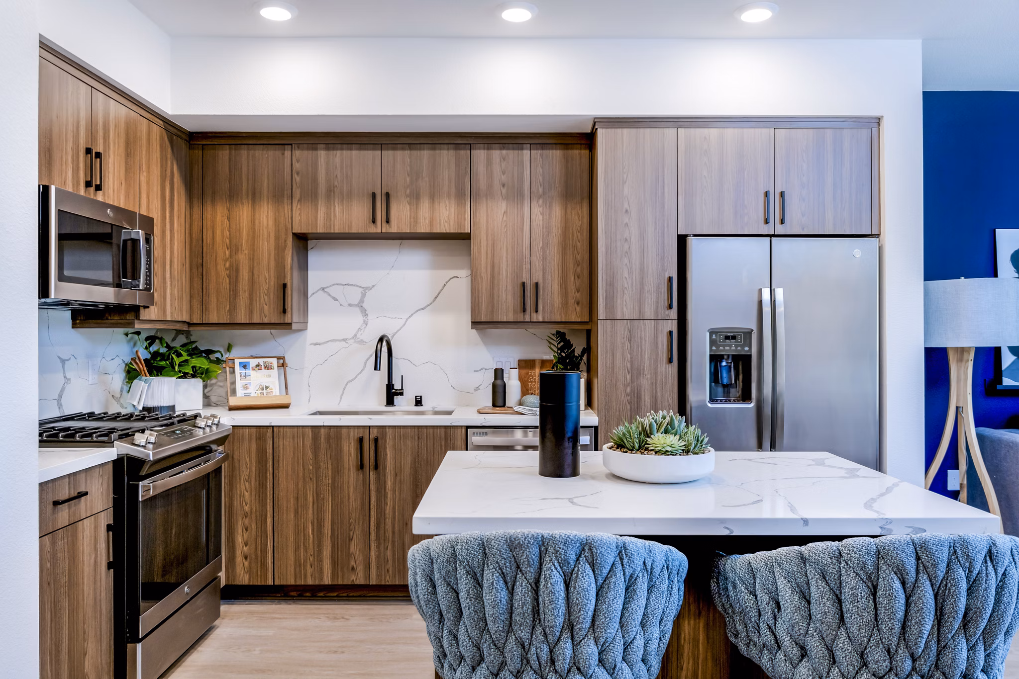 Sleek modern kitchen with stainless steel appliances at The Lofts at Carlsbad Village Apartments