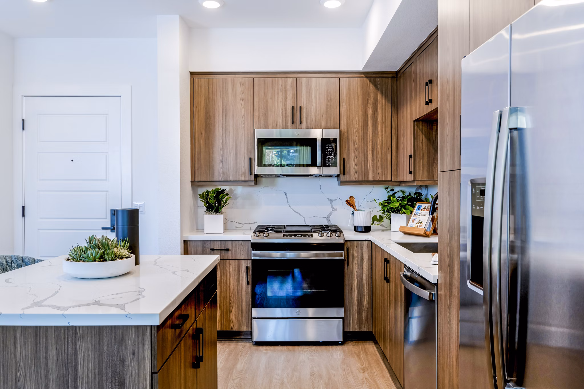 Modern kitchen with stainless steel appliances at The Lofts at Carlsbad Village Apartments