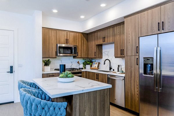 Kitchens with modern appliances and sleek countertops in The Lofts at Carlsbad Village Apartments