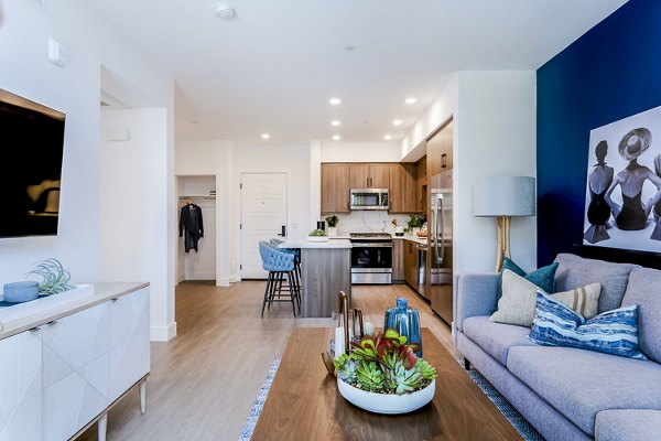 Spacious living room with contemporary decor at The Lofts at Carlsbad Village Apartments, luxury Greystar property