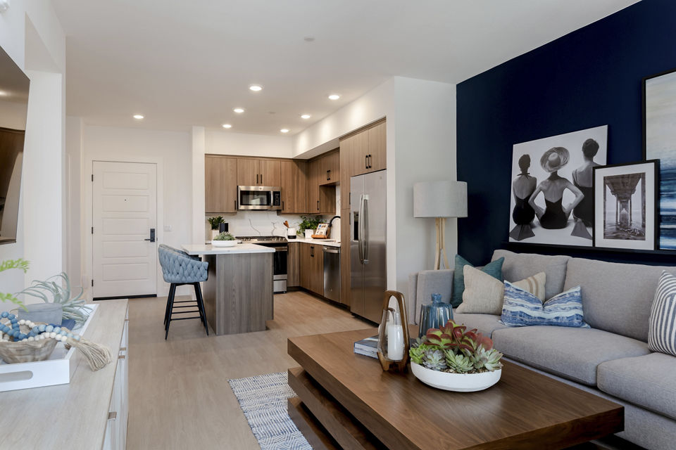 Spacious living room with contemporary decor at The Lofts at Carlsbad Village Apartments, luxury Greystar property