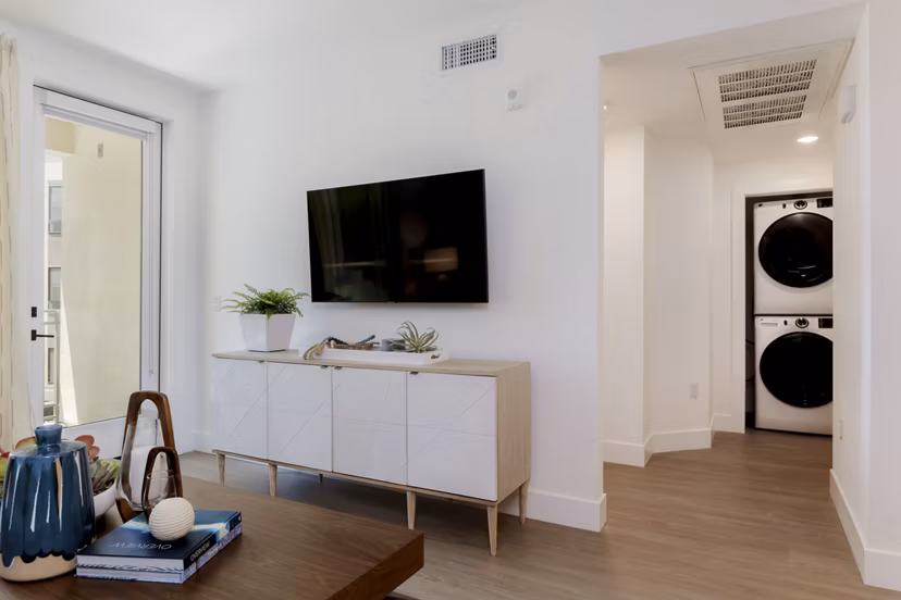 Spacious living room with modern decor in The Lofts at Carlsbad Village Apartments