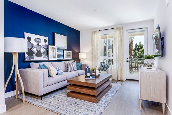 Spacious living room with modern decor in The Lofts at Carlsbad Village Apartments