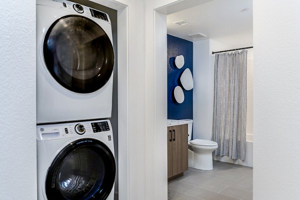 Laundry room with modern appliances at The Lofts at Carlsbad Village Apartments