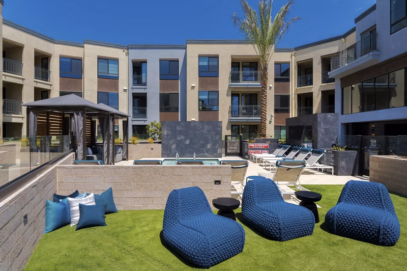 The Lofts at Carlsbad Village: Modern patio with comfortable seating in luxury apartment community